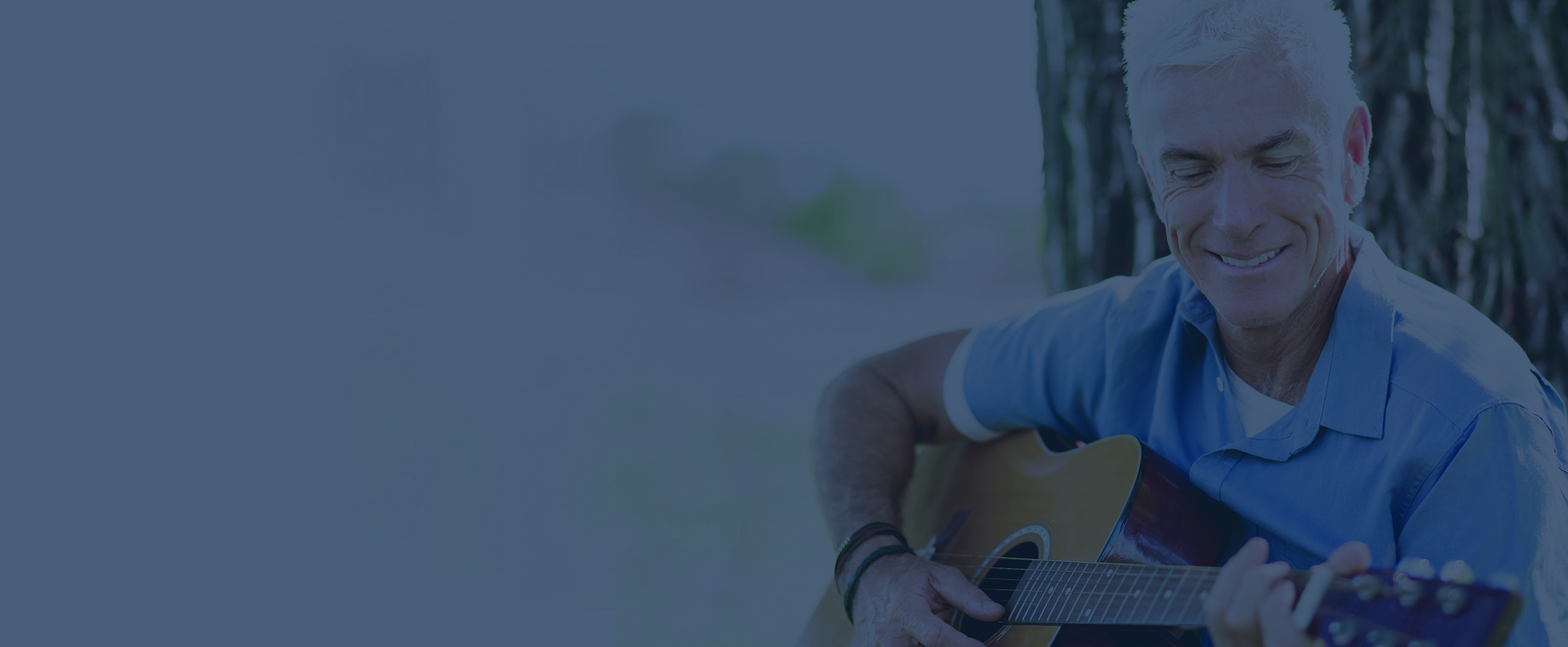 man playing guitar outside